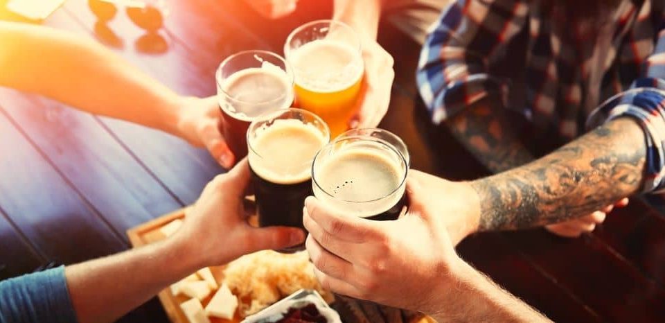 Friends toasting beer at a pub.